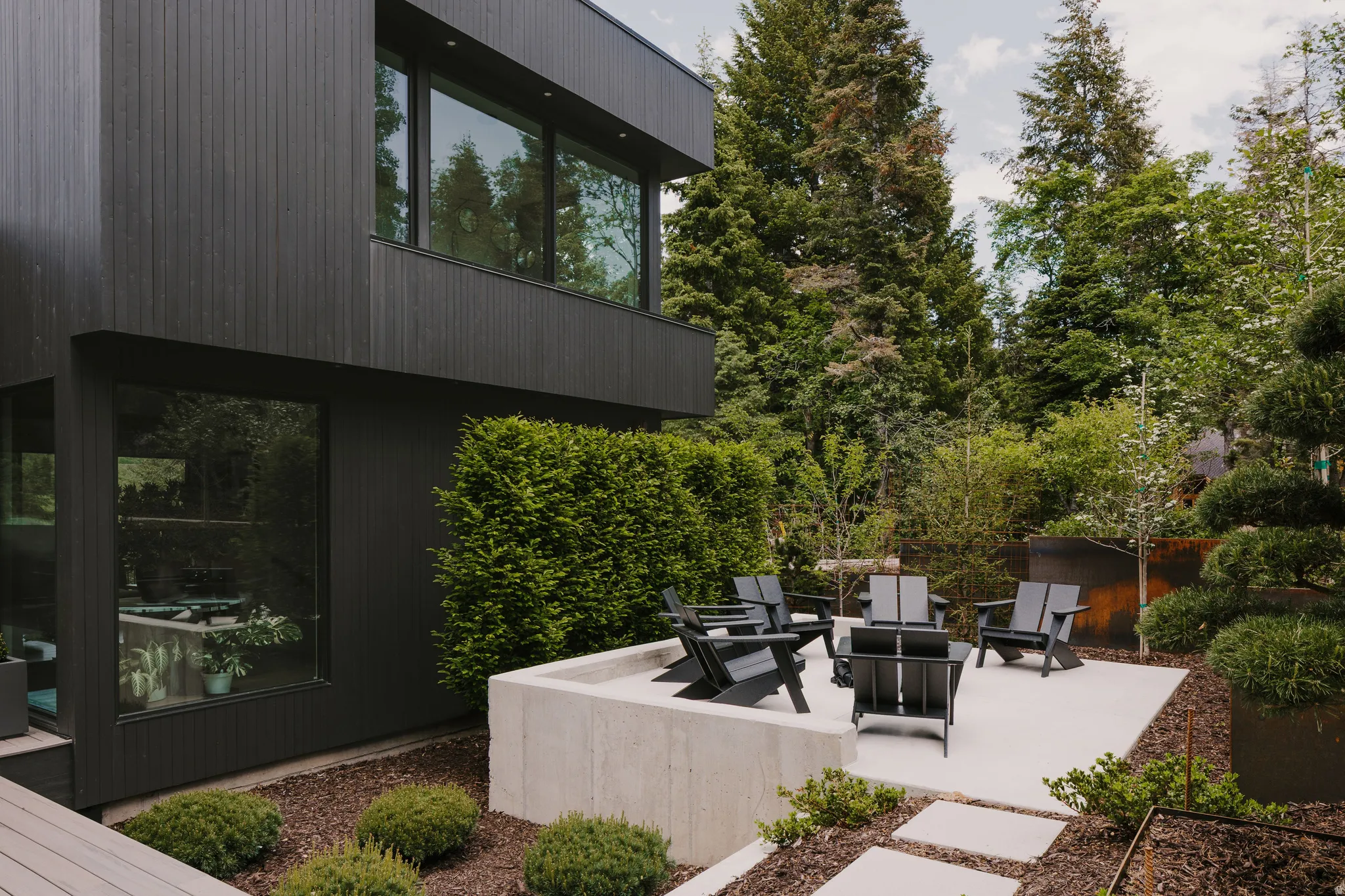 Exterior featuring modern black vertical siding and large pane windows