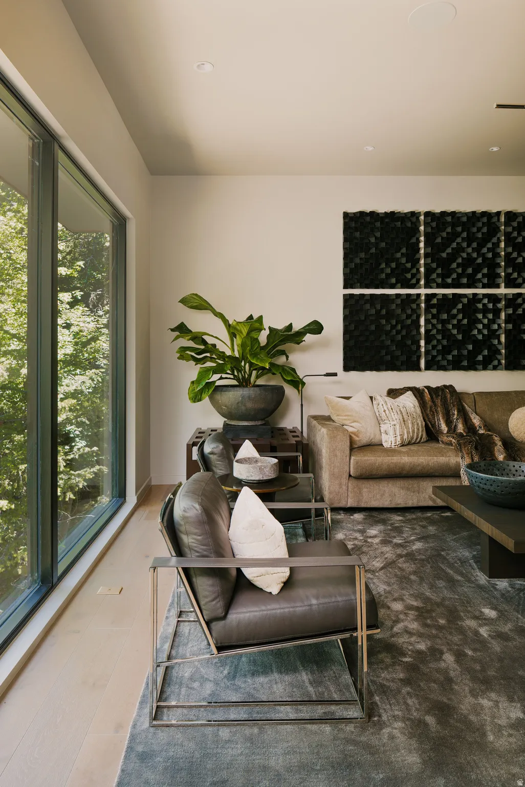 Expansive window wall overlooking lush greenery