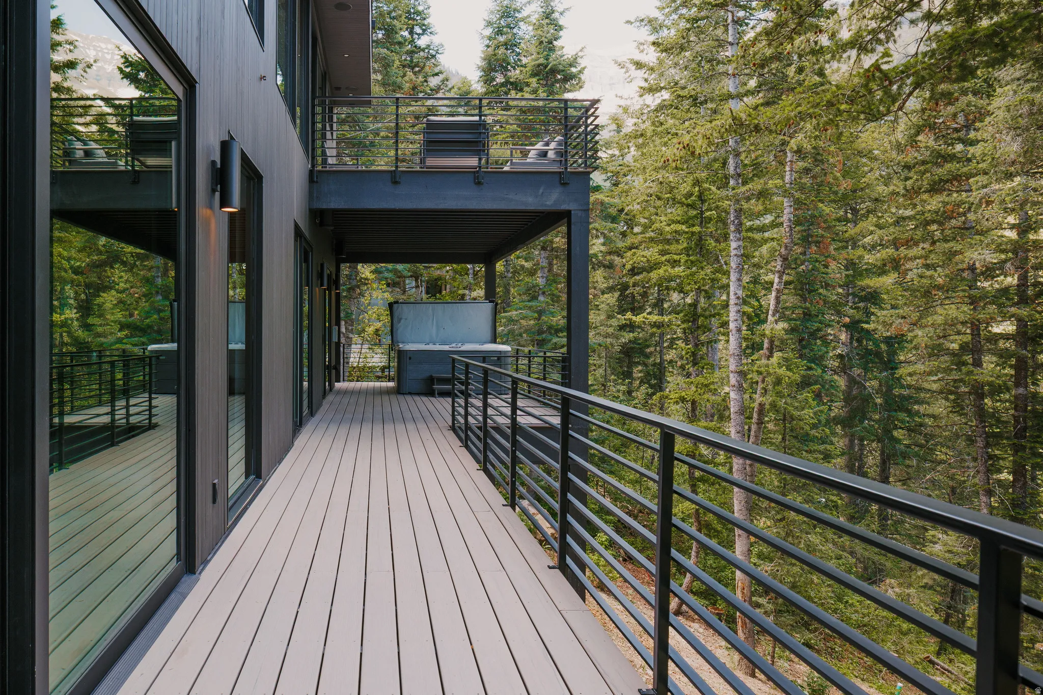 Expansive outdoor deck featuring composite decking and horizontal metal railings