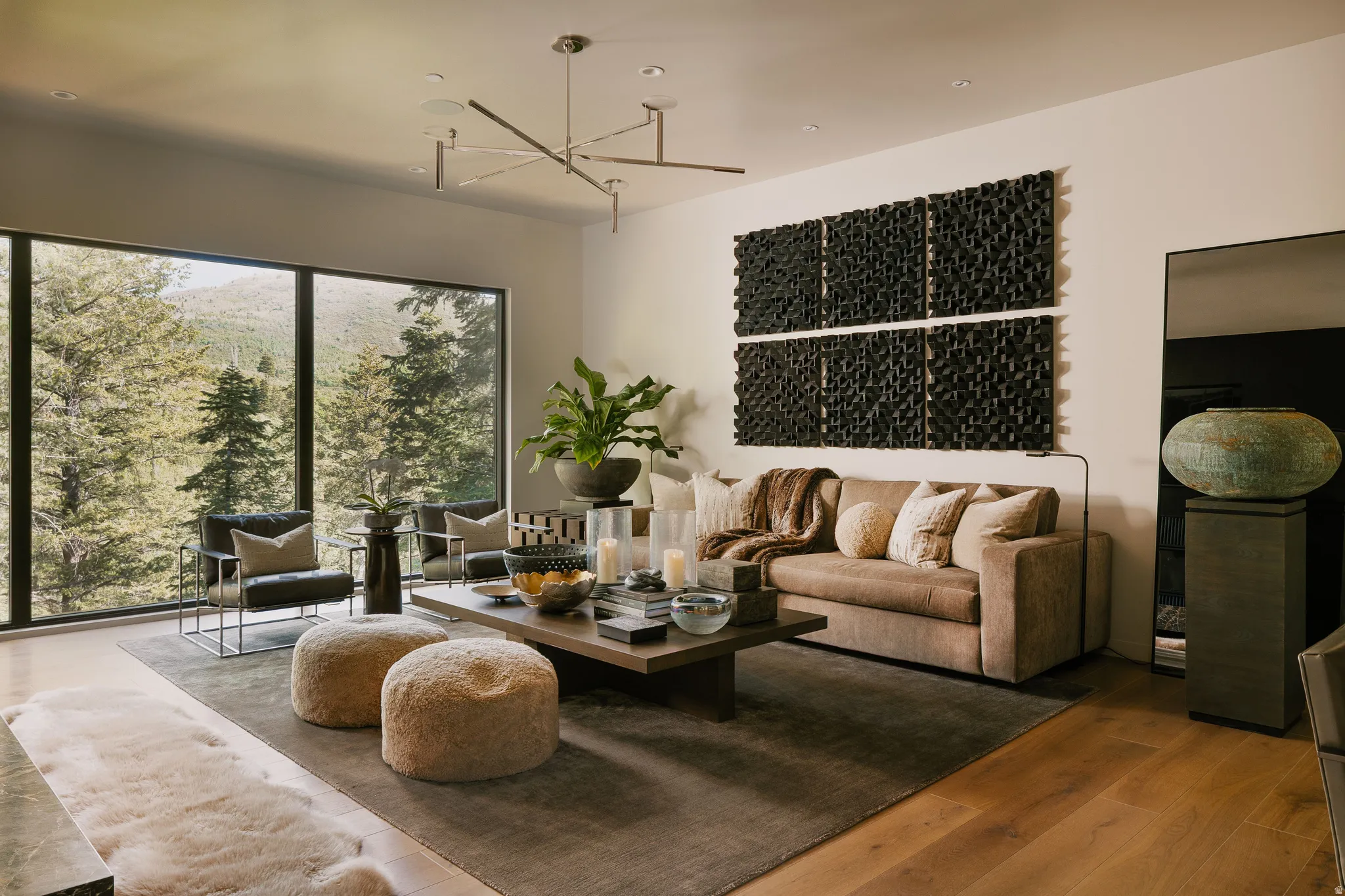Expansive living area featuring large picture windows, wood-finish flooring, a contemporary chandelier, recessed lighting, and white walls