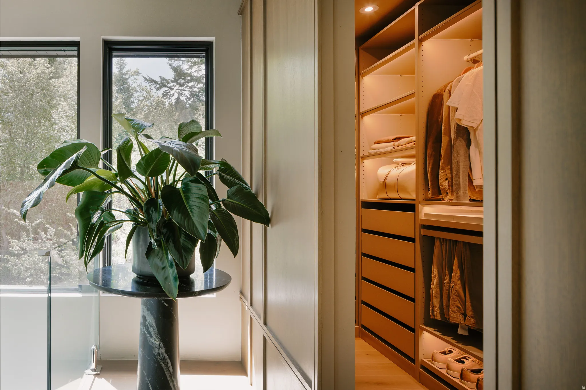 Custom closet system featuring integrated lighting, multiple shelving options, and built-in drawers