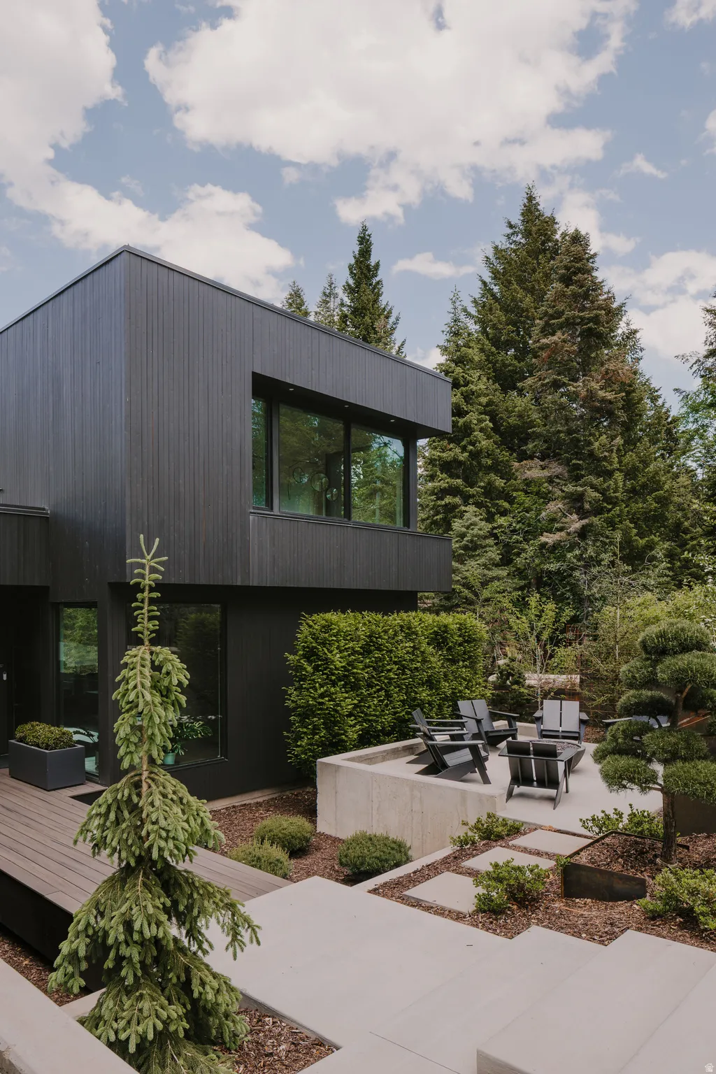 Modern exterior featuring black vertical siding and large windows