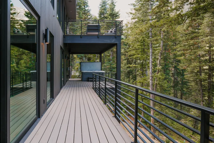 Expansive outdoor deck featuring composite decking and horizontal metal railings
