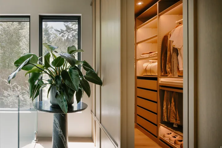 Custom closet system featuring integrated lighting, multiple shelving options, and built-in drawers
