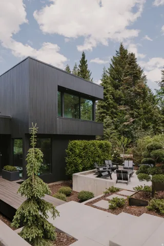 Modern exterior featuring black vertical siding and large windows