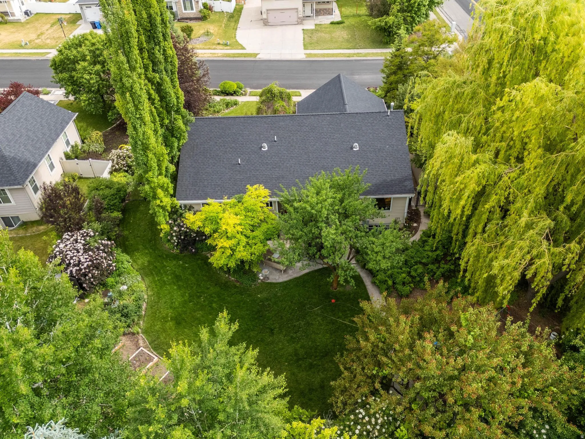 Lush landscaping featuring mature trees and established plantings