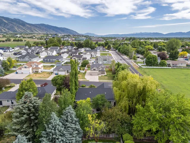 Expansive residential neighborhood featuring a variety of single-family homes with pitched roofs, mature trees, and paved streets