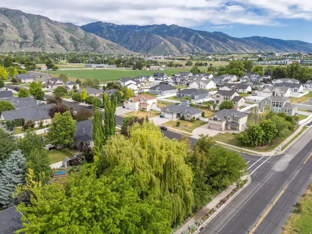 Aerial perspective showcasing a residential neighborhood with mountain backdrop