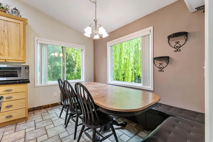 Dining area featuring large windows, vaulted ceiling, and recessed lighting