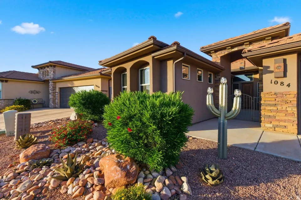 Stucco exterior with stone accents and a low-maintenance xeriscape front yard