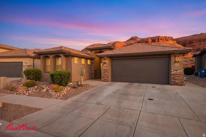 Desert contemporary residence featuring a stucco exterior, stone accents, and a tile roof