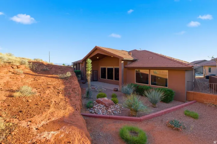 Southwest-style exterior featuring a stucco finish and tile roof