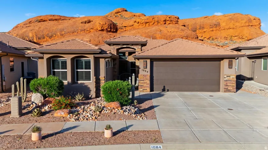 Stucco and stone exterior with a tile roof