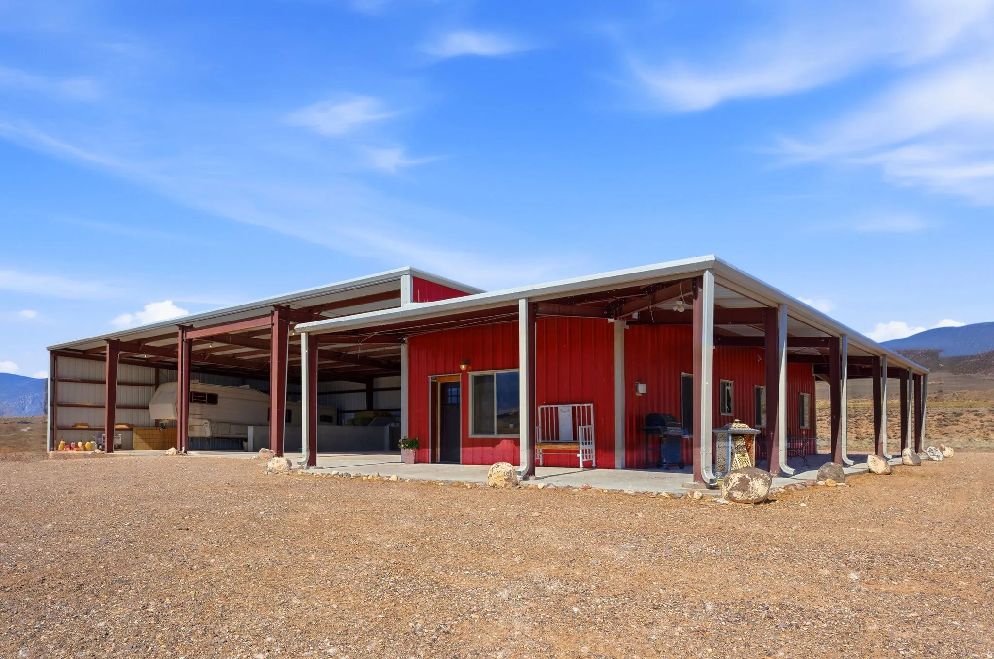 Detached ADU & Ranch Support Building 50' x 120' Approx. 6,000 sq ft total building footprint. Includes two living quarters: a 2-bed/1-bath apartment and a studio, plus RV storage, RV hookups & dump, septic tank, and equipment/storage space.