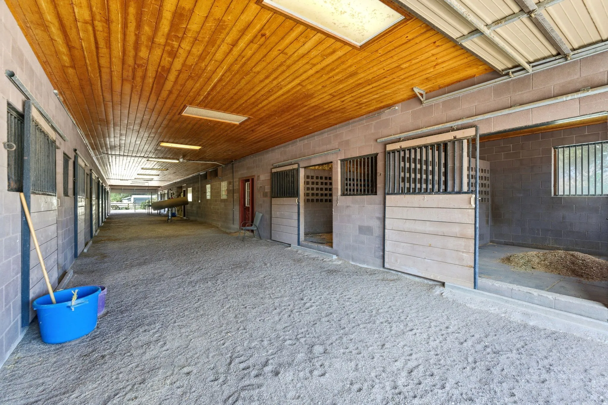 Main Breeding / Veterinary Barn, Attached/connected to the main home; includes indoor wash rack, stocks, phantom, breeding/veterinary lab, rubber mats, and indoor hot walker. 13 stalls