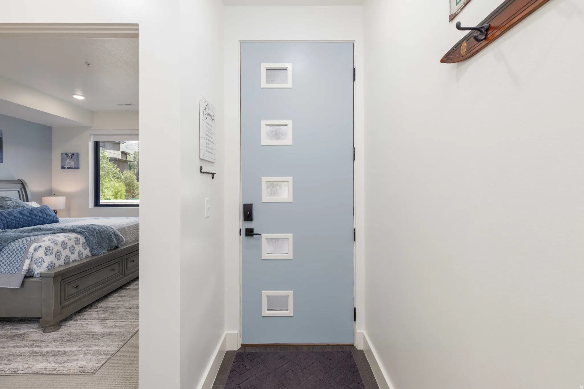 Contemporary entry door with five square window inserts and dark hardware