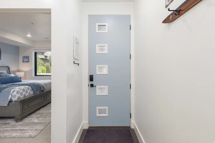 Contemporary entry door with five square window inserts and dark hardware