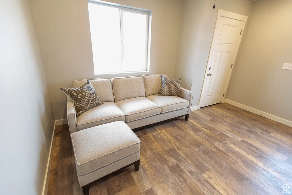 Interior room featuring wood-finish flooring, light neutral wall paint, and white trim