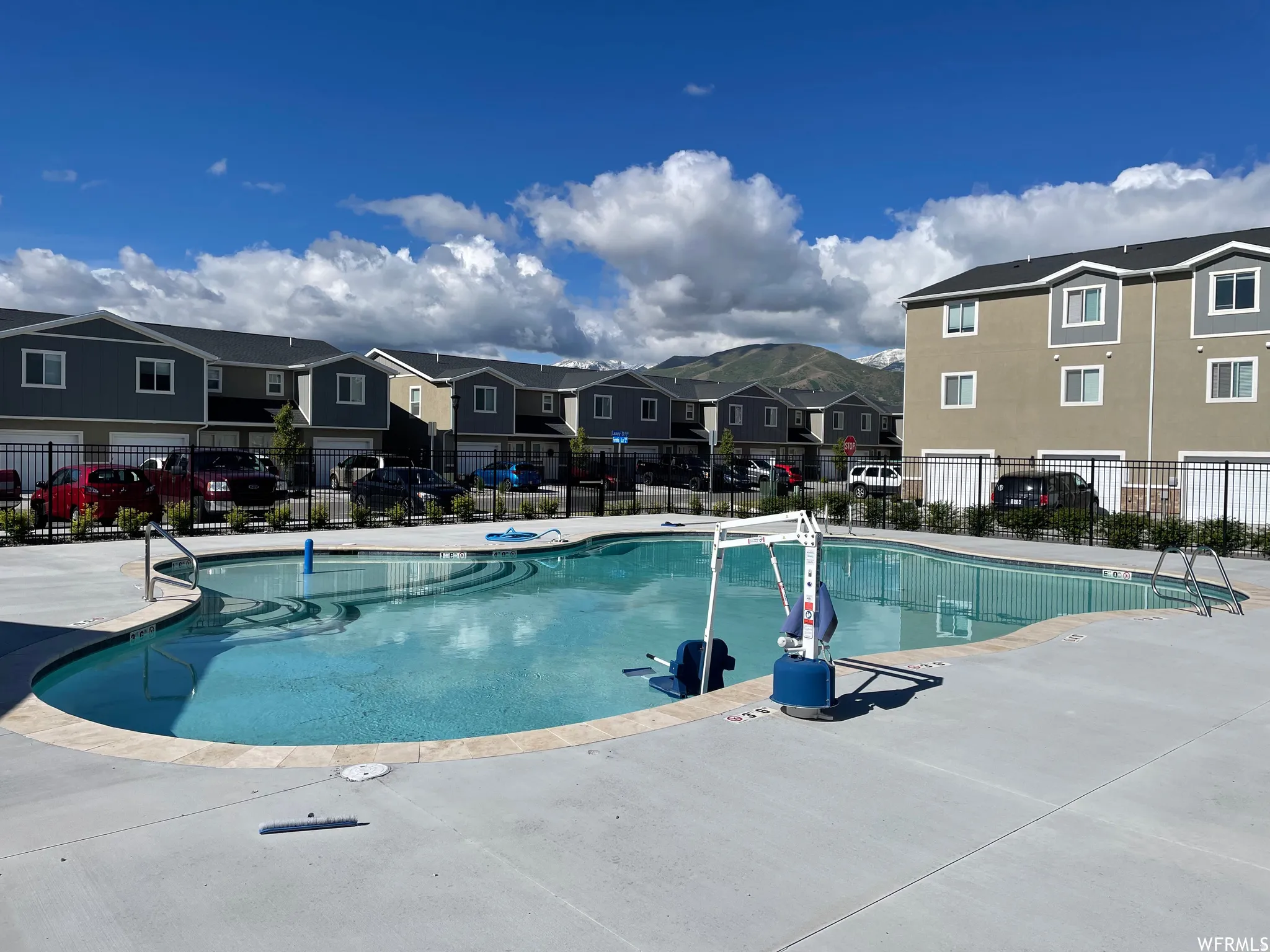 Outdoor swimming pool with concrete decking and natural stone coping