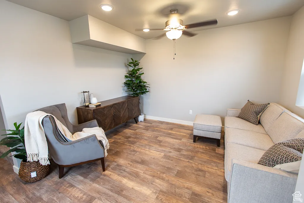 Living area featuring wood-finish flooring, recessed lighting, and a ceiling fan
