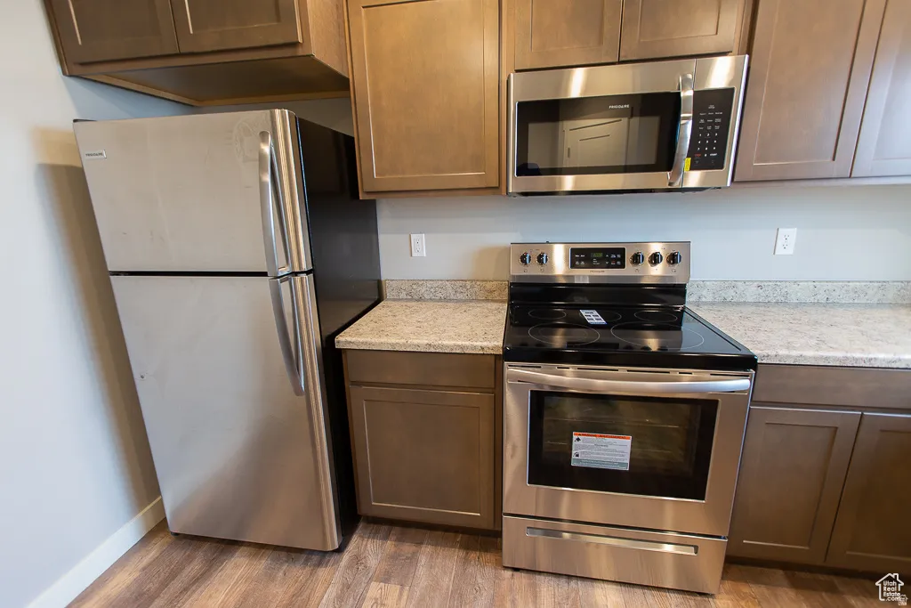 Kitchen featuring stainless steel appliances, including an oven/range, microwave, and refrigerator