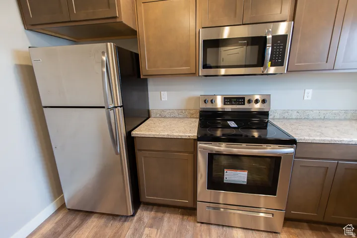 Kitchen featuring stainless steel appliances, including an oven/range, microwave, and refrigerator