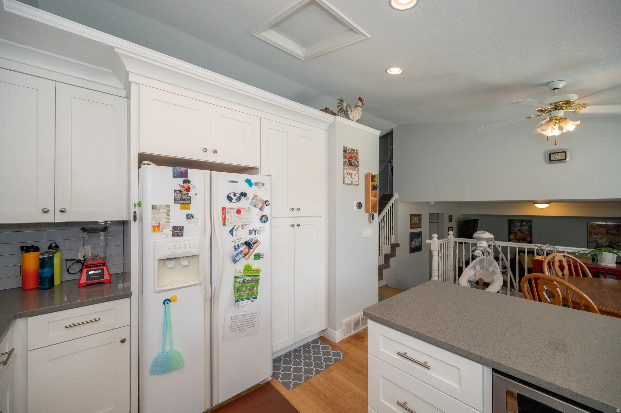 Kitchen featuring white shaker cabinetry, recessed lighting, gray subway tile backsplash, and a gray countertop