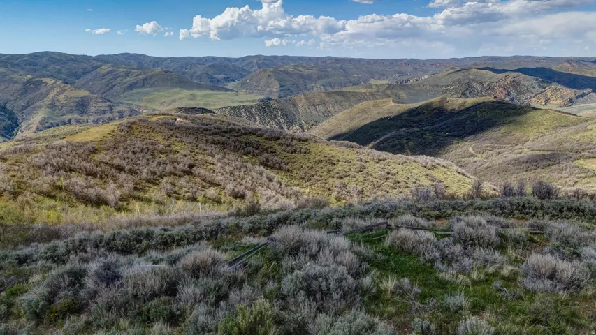 Rolling hills and distant mountains define this expansive natural landscape