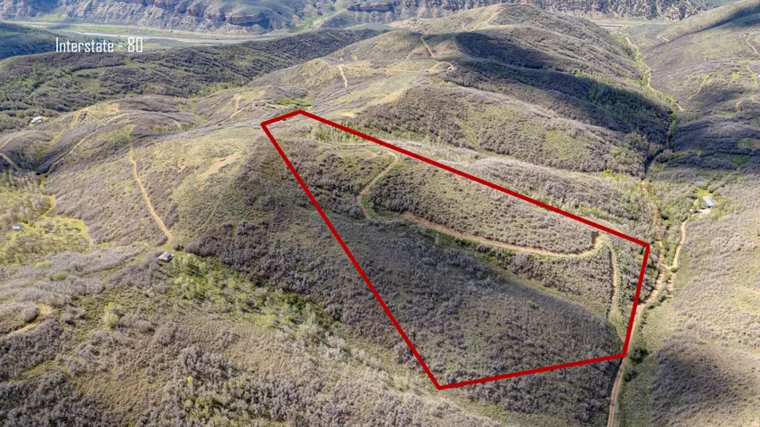 Expansive natural terrain featuring varied topography and scattered vegetation