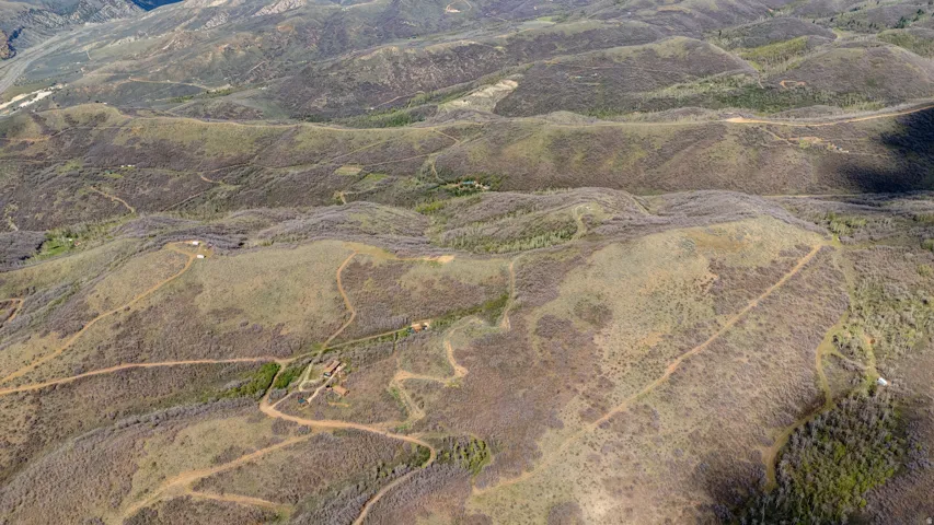 Expansive undeveloped land featuring natural terrain and visible dirt paths