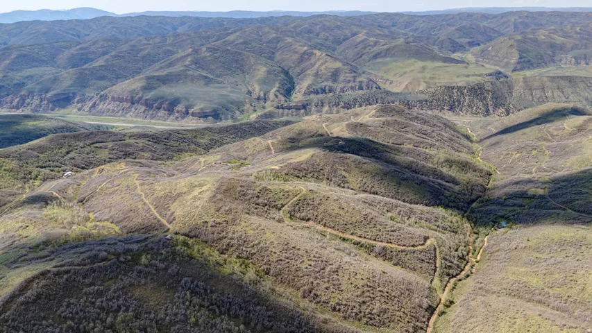 Expansive mountainous terrain with varied elevations and natural vegetation