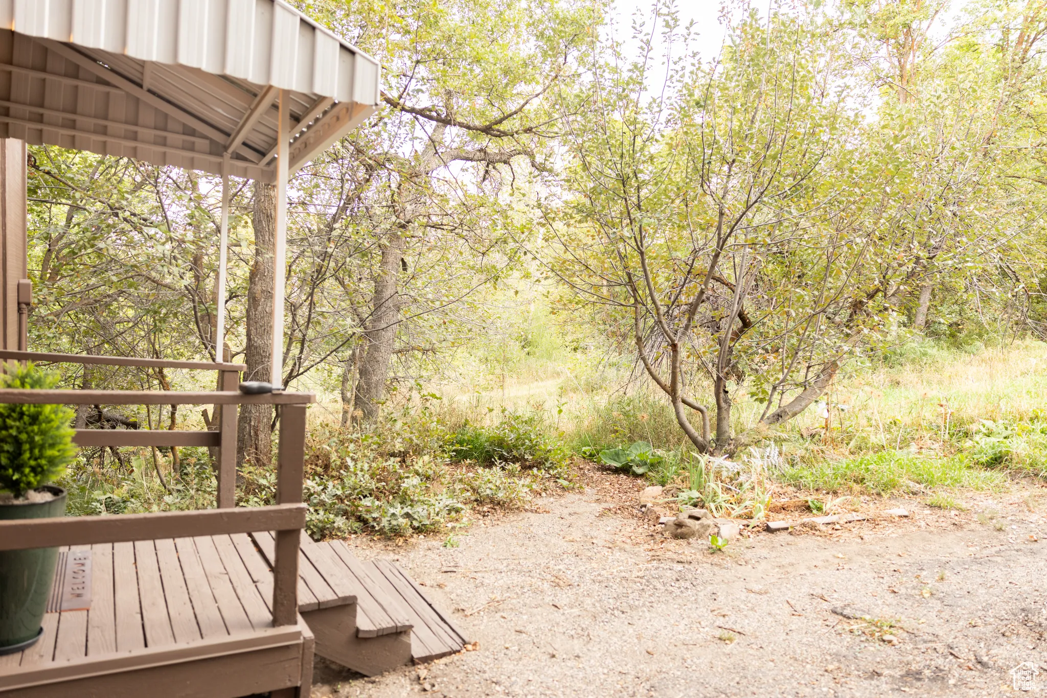 Covered porch with wood flooring and railing