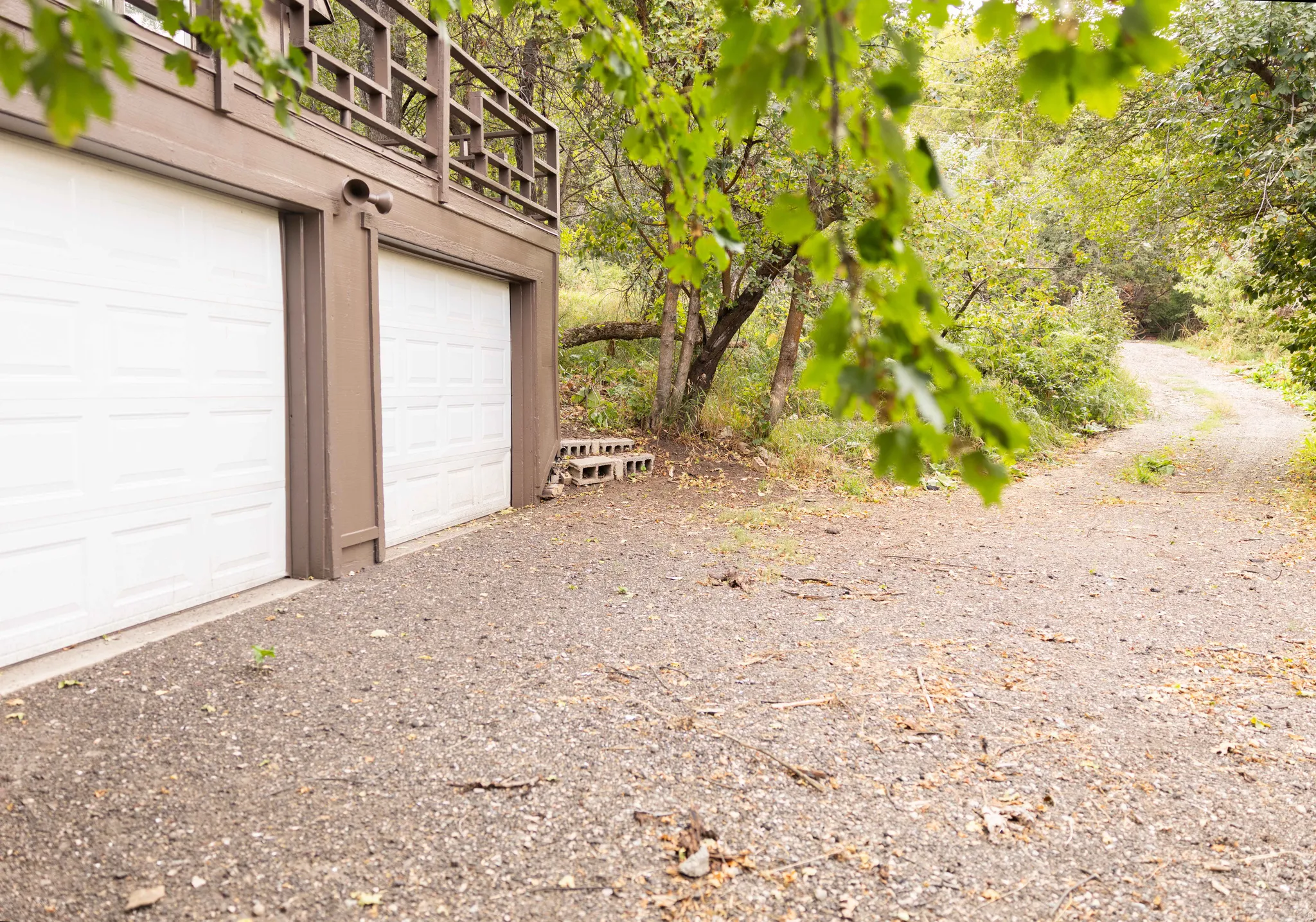 Ground-level two-car garage with white paneled doors and brown trim
