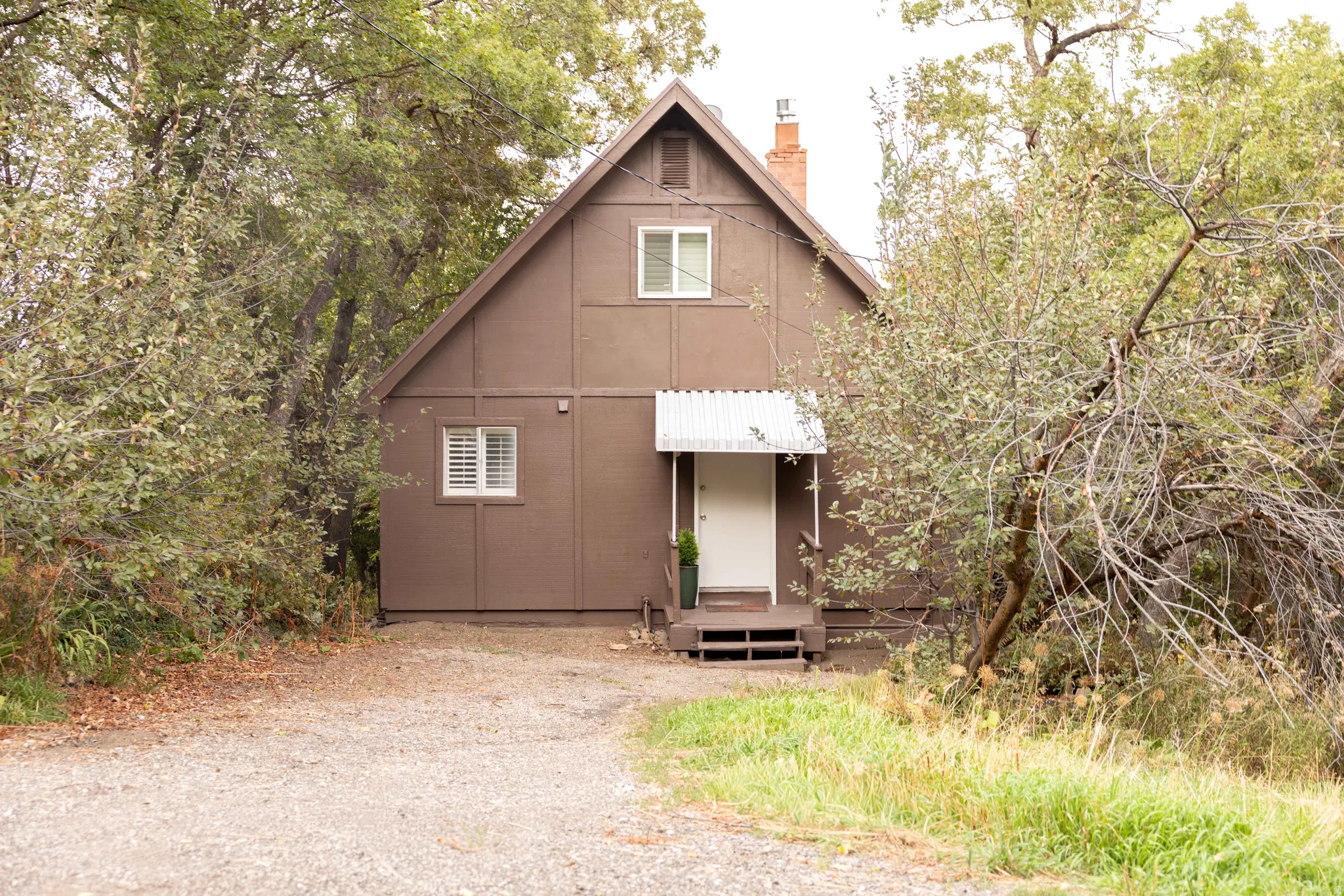A-frame style residence featuring a brown exterior with white trim