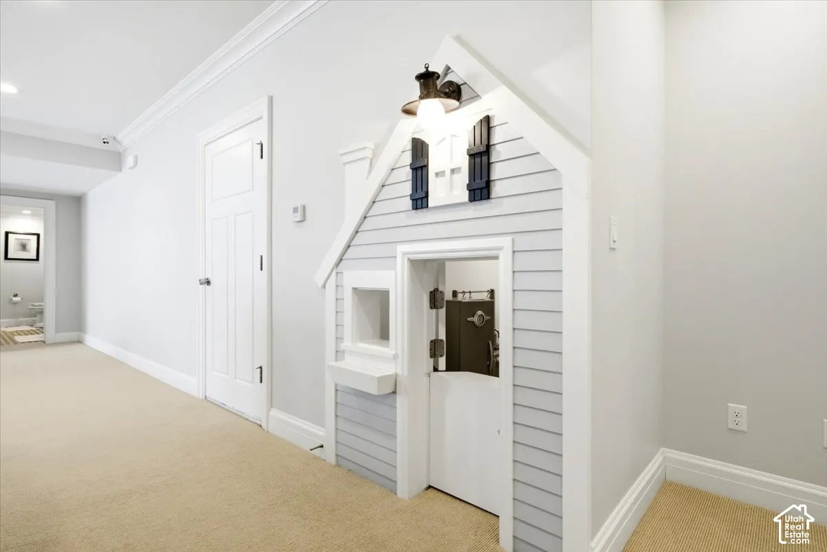 Hallway featuring a built-in playhouse with shiplap siding and decorative shutters