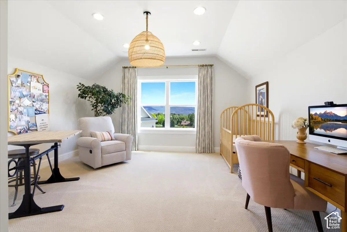 Bedroom featuring a prominent window, recessed lighting, and sloped ceilings