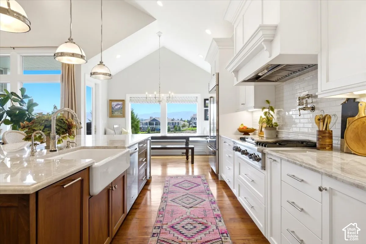 Bright kitchen featuring a vaulted ceiling and hardwood flooring