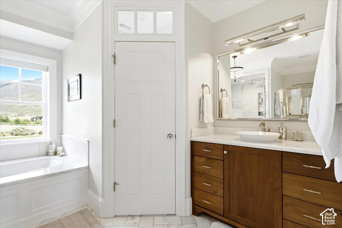 Master Bathroom featuring a wood-finish double vanity with a marble countertop and a vessel sink