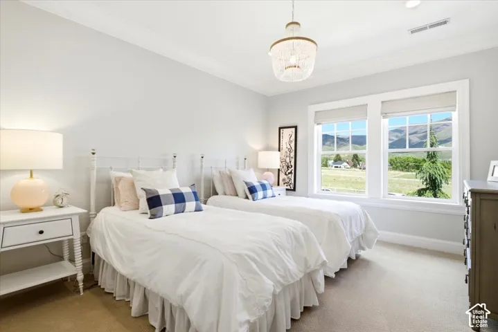Bright bedroom featuring two large windows with amazing views