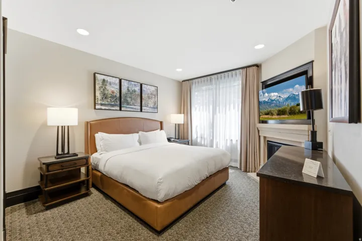 Carpeted room featuring recessed lighting and a window with sheer and blackout drapes
