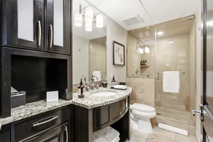 Curved vanity with a granite countertop and undermount sink