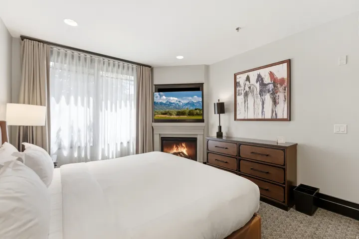 Corner fireplace with mantel, featuring an integrated television above
