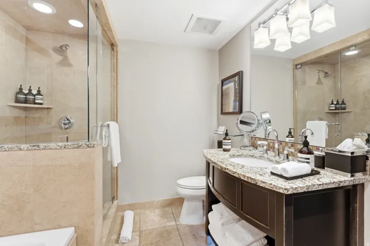 Bathroom featuring a glass-enclosed shower with recessed lighting and a built-in shelf