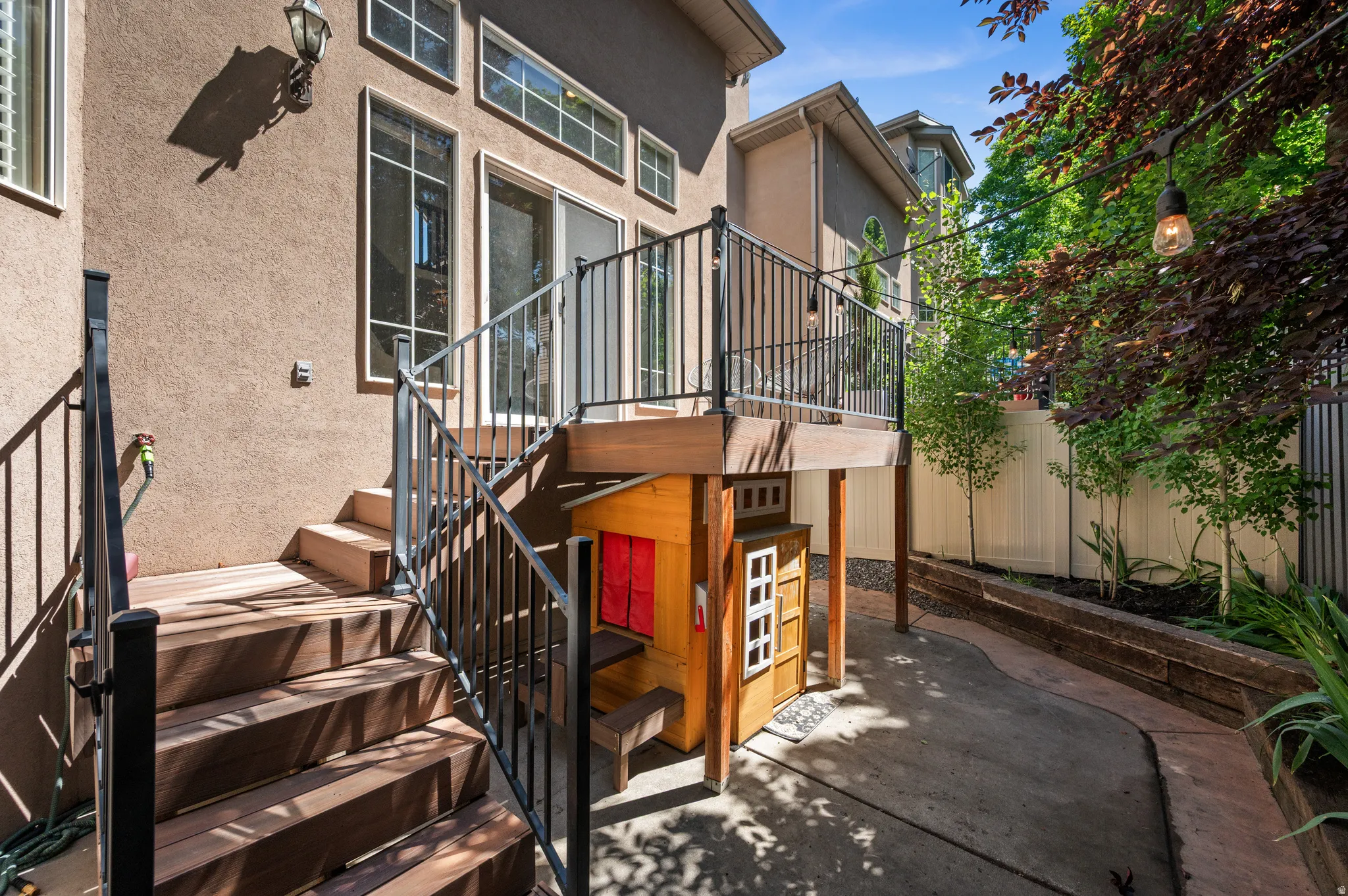 Backyard deck and pation with mature trees and plants