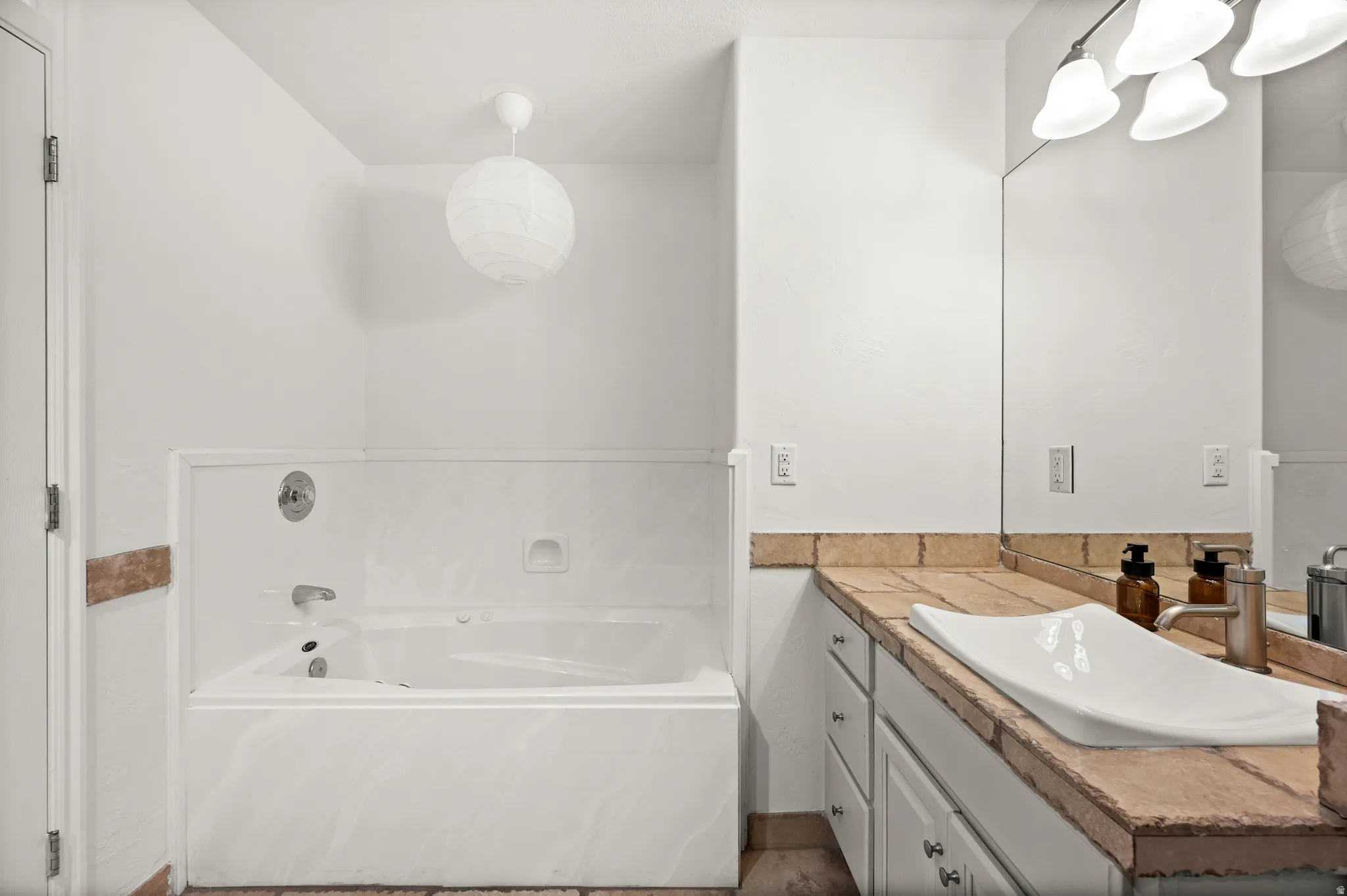 Primary bathroom featuring a jetted tub