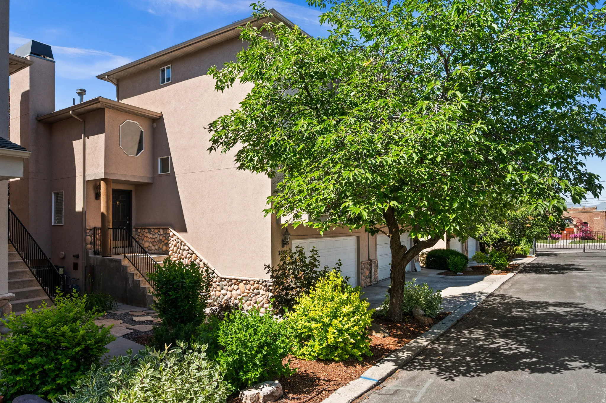 Multi-level stucco exterior with stone veneer detailing