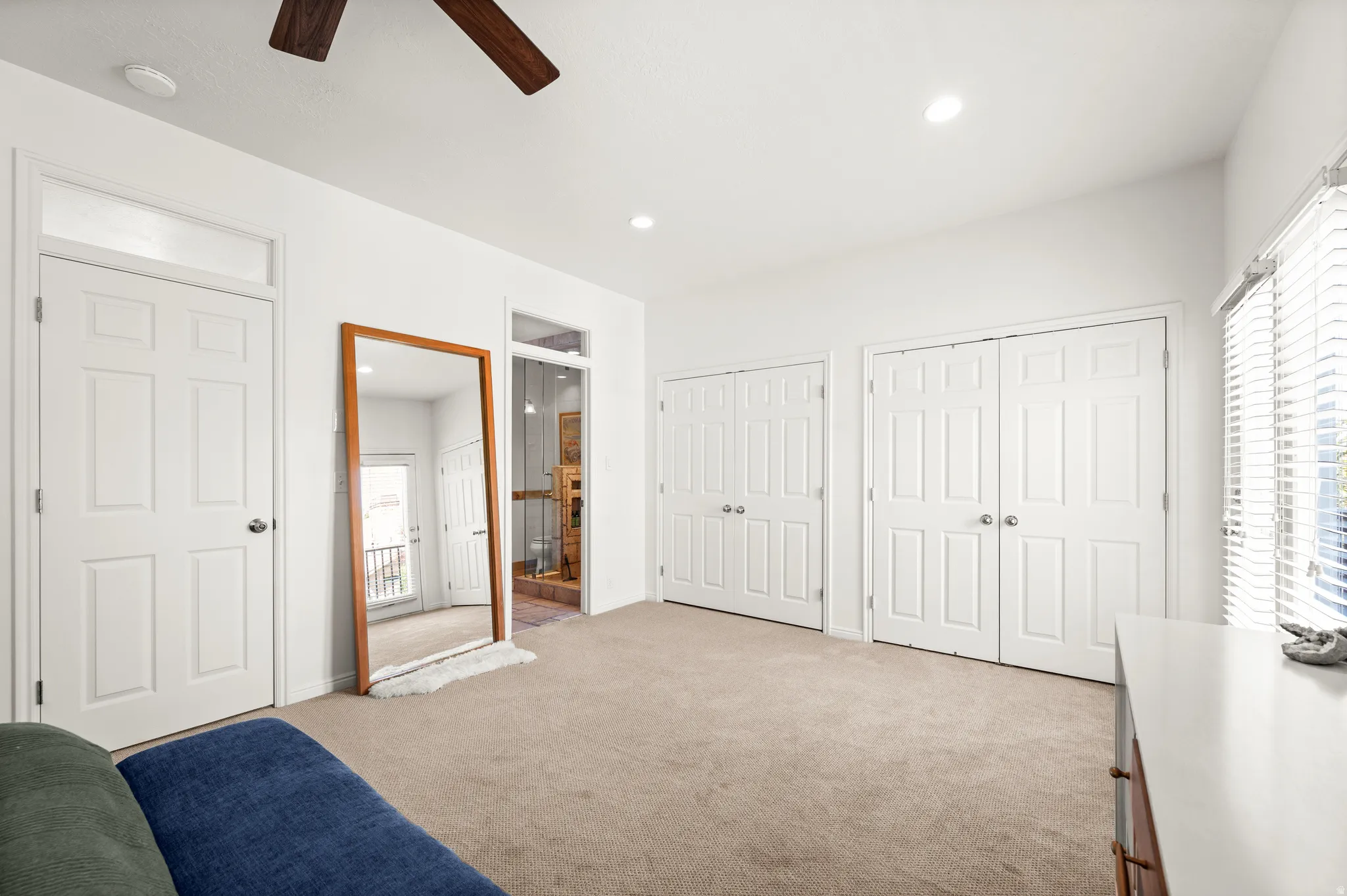 Primary bedroom featuring ensuite bathroom and double closets