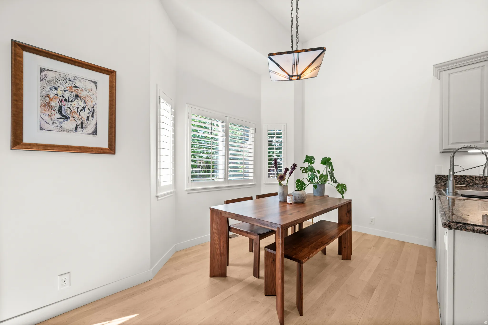 Dining area featuring vaulted ceilings,  natural light and plantation shutters