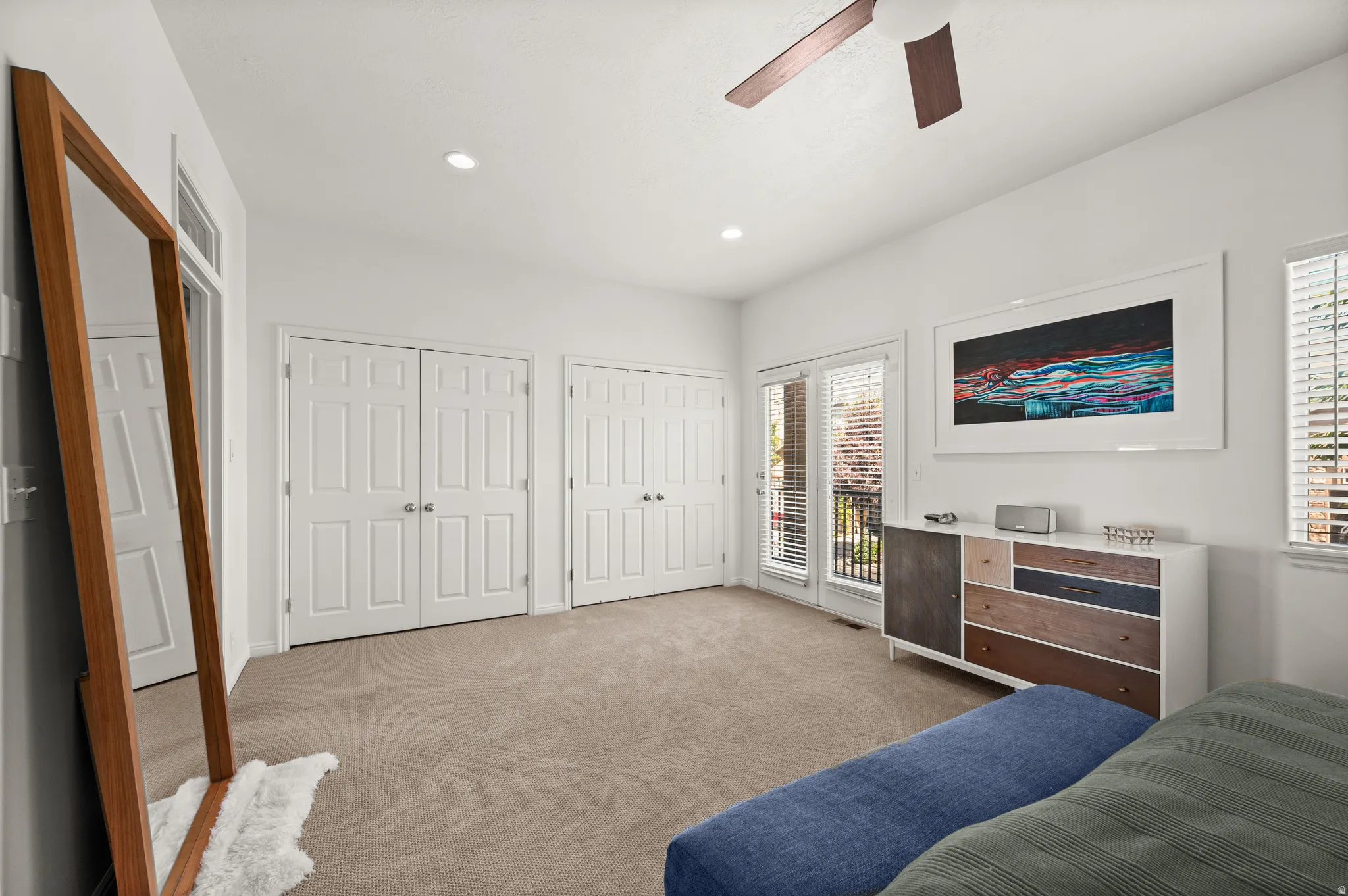 Primary bedroom featuring double closets and balcony