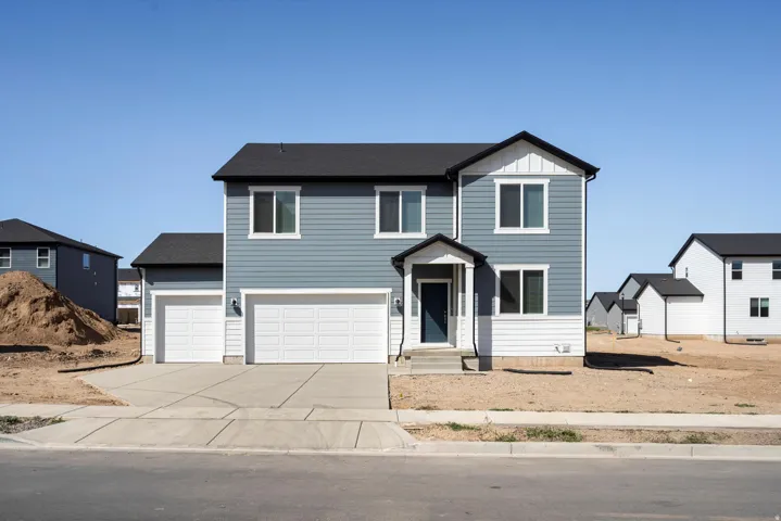 Two-story residence featuring blue horizontal siding with white trim accents and a dark roof